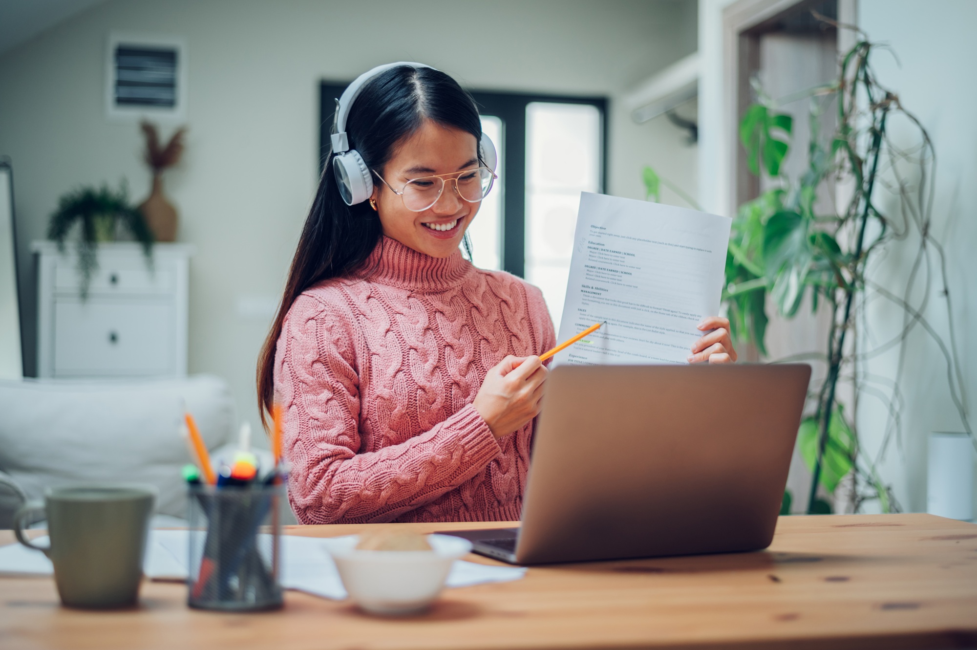 Vietnamese Asian woman using laptop at home and having a video call