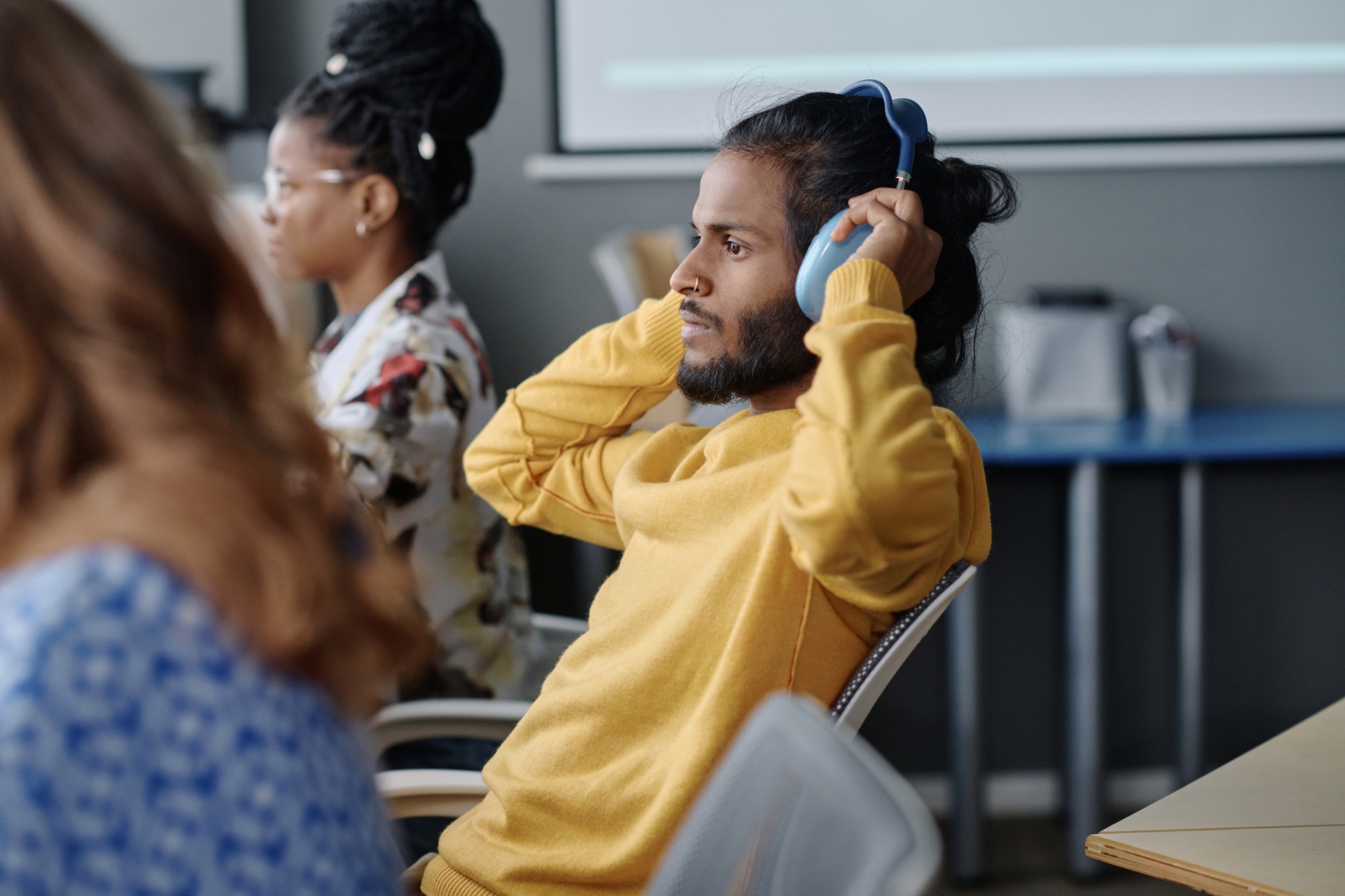 Indian Office Employee Listening to Music on His Workplace